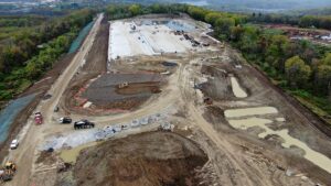 An aerial view of a large warehouse construction site being levelled, cleared, and graded.