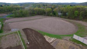 An aerial view of a newly graded storm water retention basin at Matrix Logistics Center in Newburgh, New York