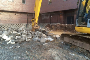Demolition in progress by an excavator at the Teachers Village in Newark